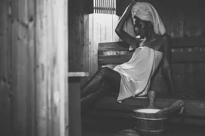 a woman in a dress sitting on a bench at The Victory Residences Bangkok in Bangkok