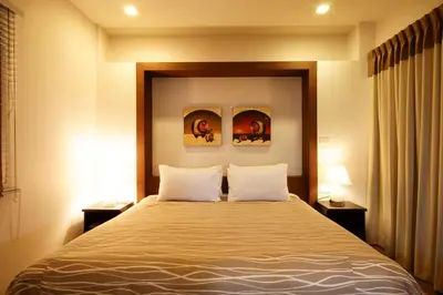 a bedroom with a large bed with two pillows at I Residence Hotel Sathorn in Bangkok