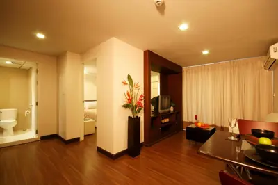 a living room with a toilet and a television at I Residence Hotel Sathorn in Bangkok