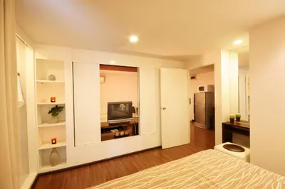 a room with a bed and a television in it at I Residence Hotel Sathorn in Bangkok