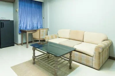 a living room with a couch and a coffee table at Bangkok Loft at Nana Station in Bangkok