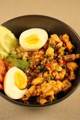 a pan full of food with eggs and vegetables at The Dawin Hotel in Bangkok