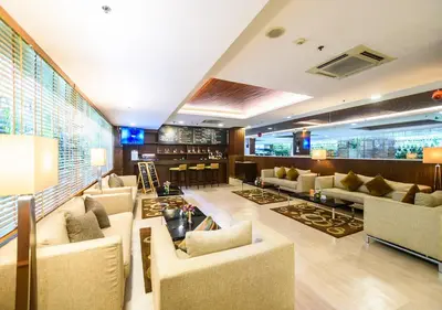 a hotel lobby with couches and a bar at Lohas Residences Sukhumvit 2 in Bangkok
