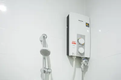 a shower in a bathroom with a thermostat at Twentynine KV Apartel in Nonthaburi