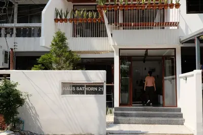 a man walks into the entrance of a building at Haus Sathorn 21 Bed and Breakfast in Bangkok