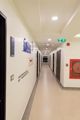 a hallway in a hospital with signs on the wall at Tarawish Hotel in Bangkok