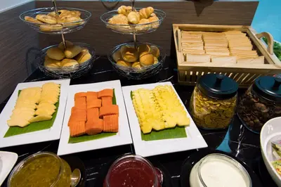 a table topped with different types of food on plates at Tarawish Hotel in Bangkok