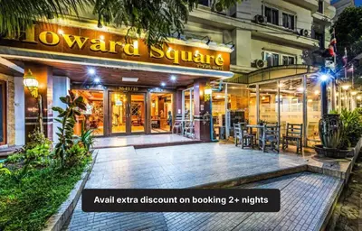 a restaurant with a sign on the front of a building at Collection O Howard Square Boutique Hotel in Bangkok