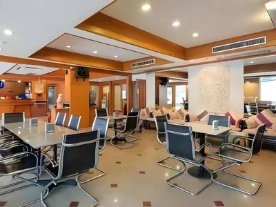 a conference room with tables and chairs in a building at Collection O Howard Square Boutique Hotel in Bangkok