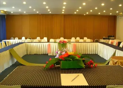 a conference room with a table with flowers on it at Collection O Howard Square Boutique Hotel in Bangkok