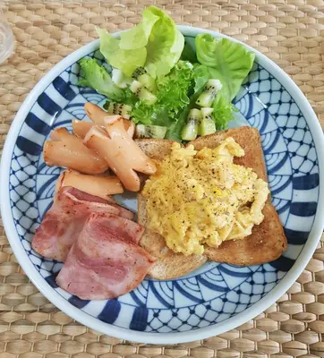 a blue and white plate of food with bread and vegetables at The Companion in Bangkok