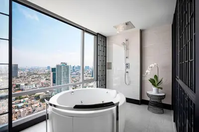 a bathroom with a tub and a large window at Bangkok Marriott Hotel The Surawongse in Bangkok