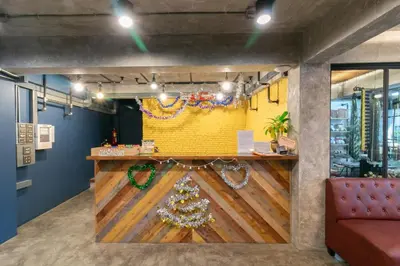 a bar with a christmas tree on the wall at Zleepmotion Bangkok in Bangkok