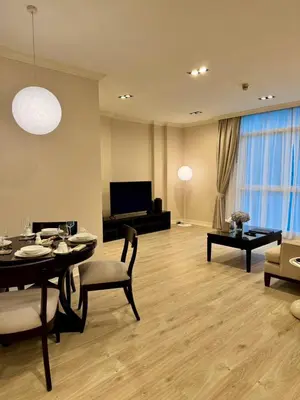 a living room with a table and a couch at Rongratana Executive Residence Bangkok in Bangkok