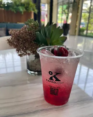 a drink in a cup sitting on a table at BoonRumpa Accommodation in Bangkok
