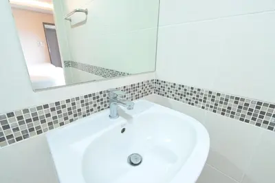 a bathroom with a white sink and a mirror at Sleep Hotel Bangkok in Bangkok