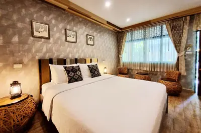 a bedroom with a large white bed and a window at Focal Local Bed & Breakfast in Bangkok