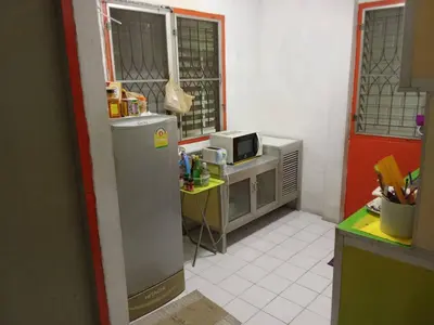 a kitchen with a refrigerator and a microwave at Young and Beautiful in Bangkok