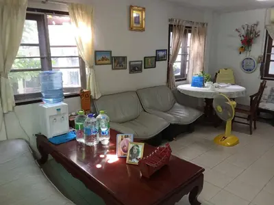 a living room with a couch and a table at Young and Beautiful in Bangkok