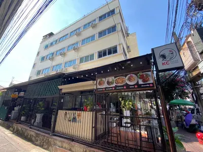 a restaurant on a street with a building at KC guest house in Bangkok
