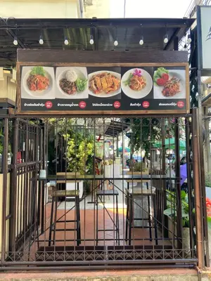 a restaurant with plates of food on top of it at KC guest house in Bangkok