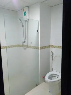 a bathroom with a shower and a toilet at Tongpoon Hotel in Bangkok
