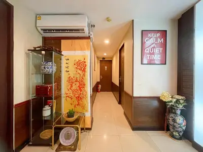 a hallway of a building with a vase of flowers at Arawana Express Chinatown in Bangkok