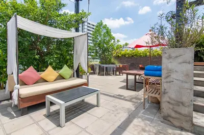 a patio with a couch and a table at Galleria 10 Hotel Bangkok in Bangkok