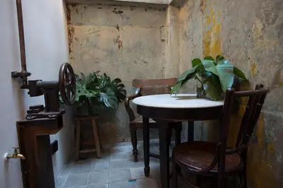 a room with a table and chairs and a plant at 1905 Heritage Corner in Bangkok