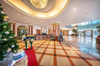 a christmas tree in the middle of a lobby at Royal Benja Hotel - Big Rooms, Family Friendly in Bangkok
