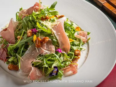 a white plate with a salad with meat on it at AETAS lumpini in Bangkok