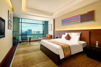 a hotel room with a bed and a large window at AETAS lumpini in Bangkok