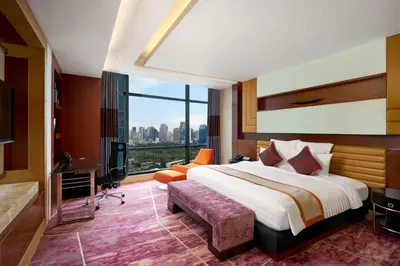 a hotel room with a bed and a large window at AETAS lumpini in Bangkok