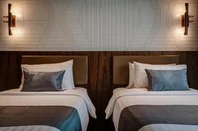 a room with two beds and two lights on the wall at Sib Kao in Bangkok