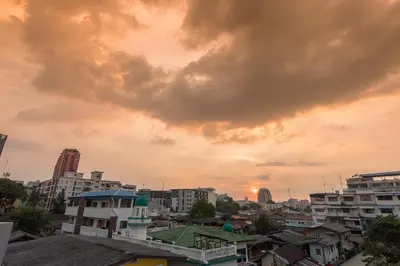 a view of a city at sunset at BaanSu Hostel in Bangkok
