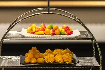a plate of fruit on a tray on a shelf at MUU Bangkok, Small Luxury Hotels of the World in Bangkok