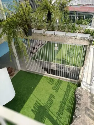 an overhead view of a garden with a fence and grass at Pastelhouse hostel in Bangkok