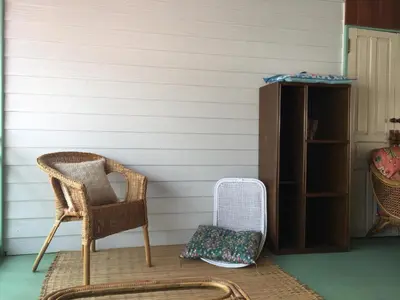 a wicker chair and a radiator on a porch at Home & Hashery Boutique House in Bangkok
