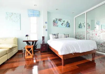 a bedroom with a bed and a couch at Ayi Home in Bangkok