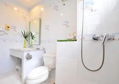 a white bathroom with a shower and a toilet at Ayi Home in Bangkok
