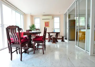 a kitchen and dining room with a table and chairs at Ayi Home in Bangkok
