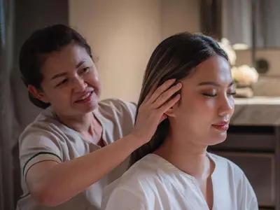 a woman helping a girl with her hair at VIE Hotel Bangkok - MGallery Collection in Bangkok