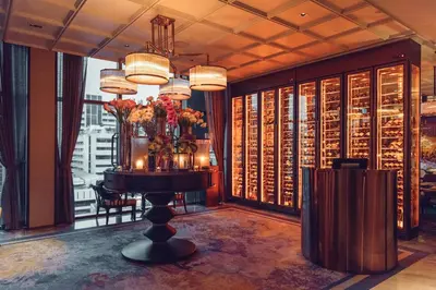 a room with a table with flowers on it at VIE Hotel Bangkok - MGallery Collection in Bangkok