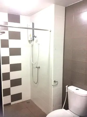 a bathroom with a shower with a toilet at Live at Home Sukhumvit 105 in Bangkok