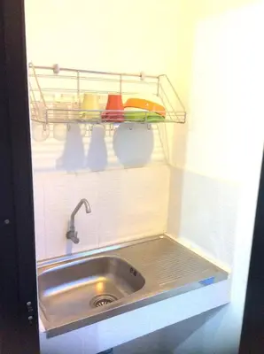 a kitchen sink with a shelf above it at Live at Home Sukhumvit 105 in Bangkok