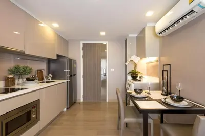 a kitchen and dining room with a table and chairs at Dazzle Residence in Bangkok