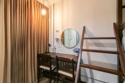 a bathroom with a vanity and a mirror at Phobphan Hostel in Bangkok