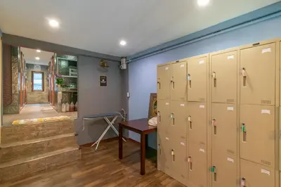 a locker room with lockers and a staircase at Phobphan Hostel in Bangkok