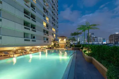 a swimming pool in a building at night at BU Place Hotel in Bangkok