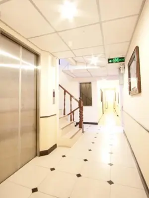 an empty hallway of an office building with a tiled floor at Honey House 2 in Bangkok